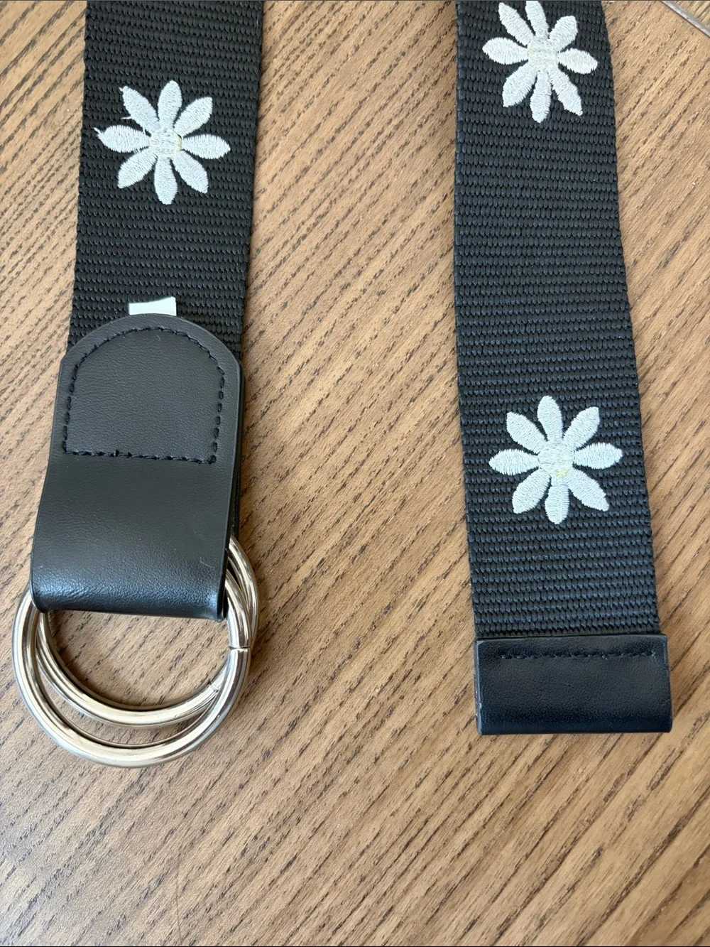 Black Webbed Belt with White Daisy Embroidered Design and Silver Ring Closure